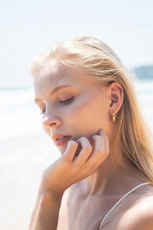Gold chubby hoop earrings styled with minimalist outfit