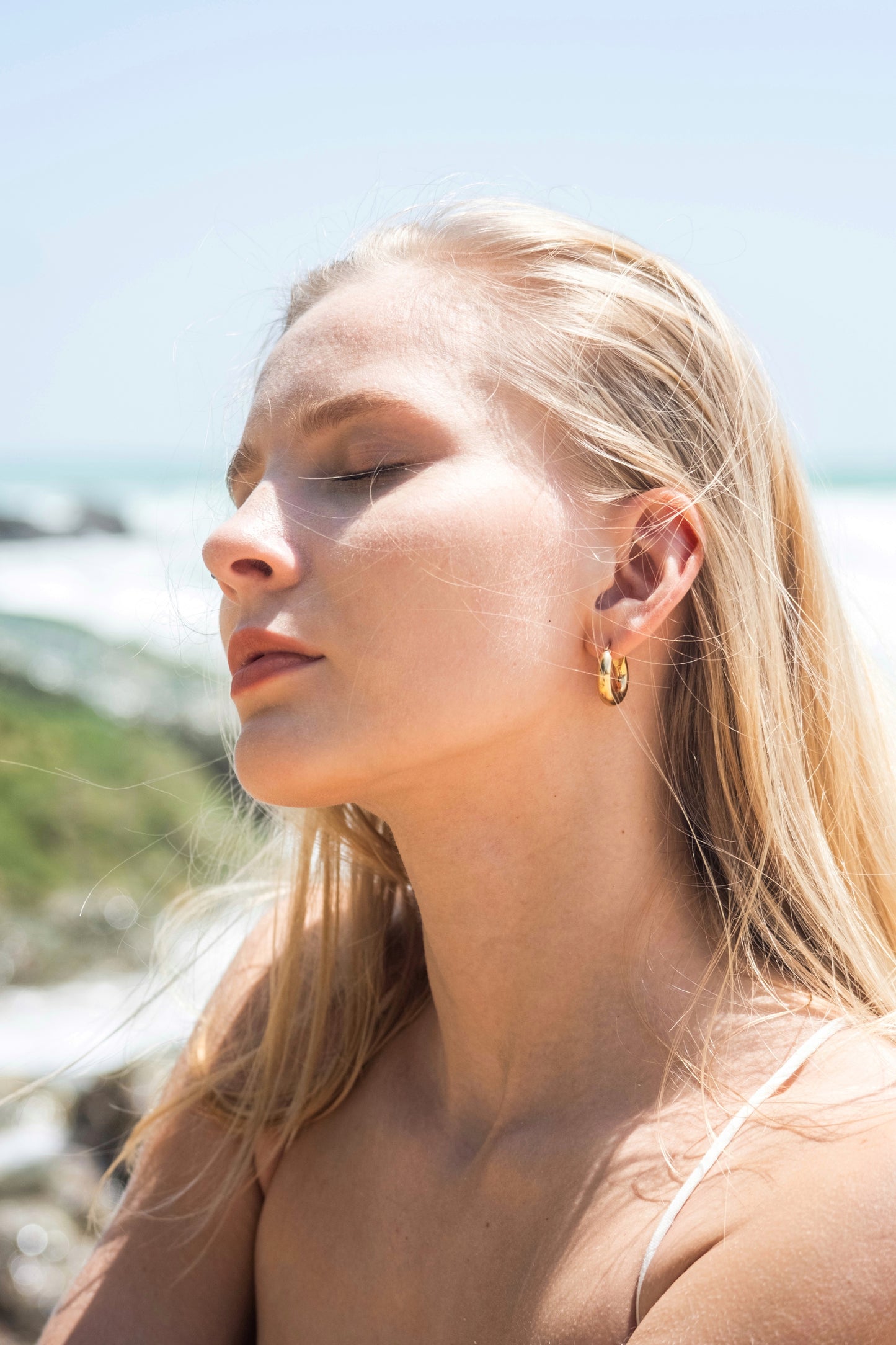 18k gold waterproof chubby hoop earrings on model